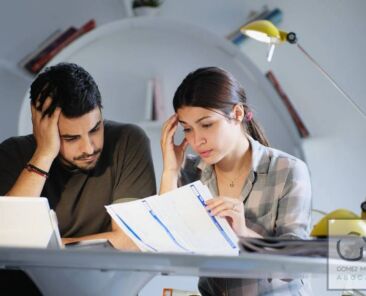 Young couple reviewing invoices and doing family business plan. Concept of money and economic problem for man and woman living together